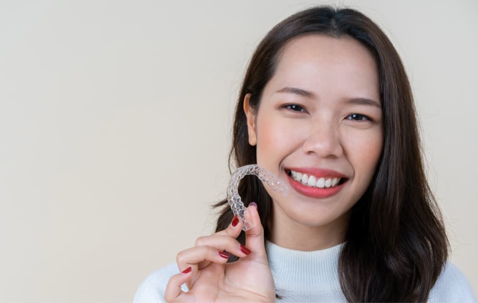 teen brother and sister hugging and smiling wearing braces
