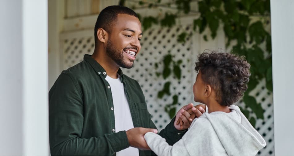 man smiling wearing traditional metal braces